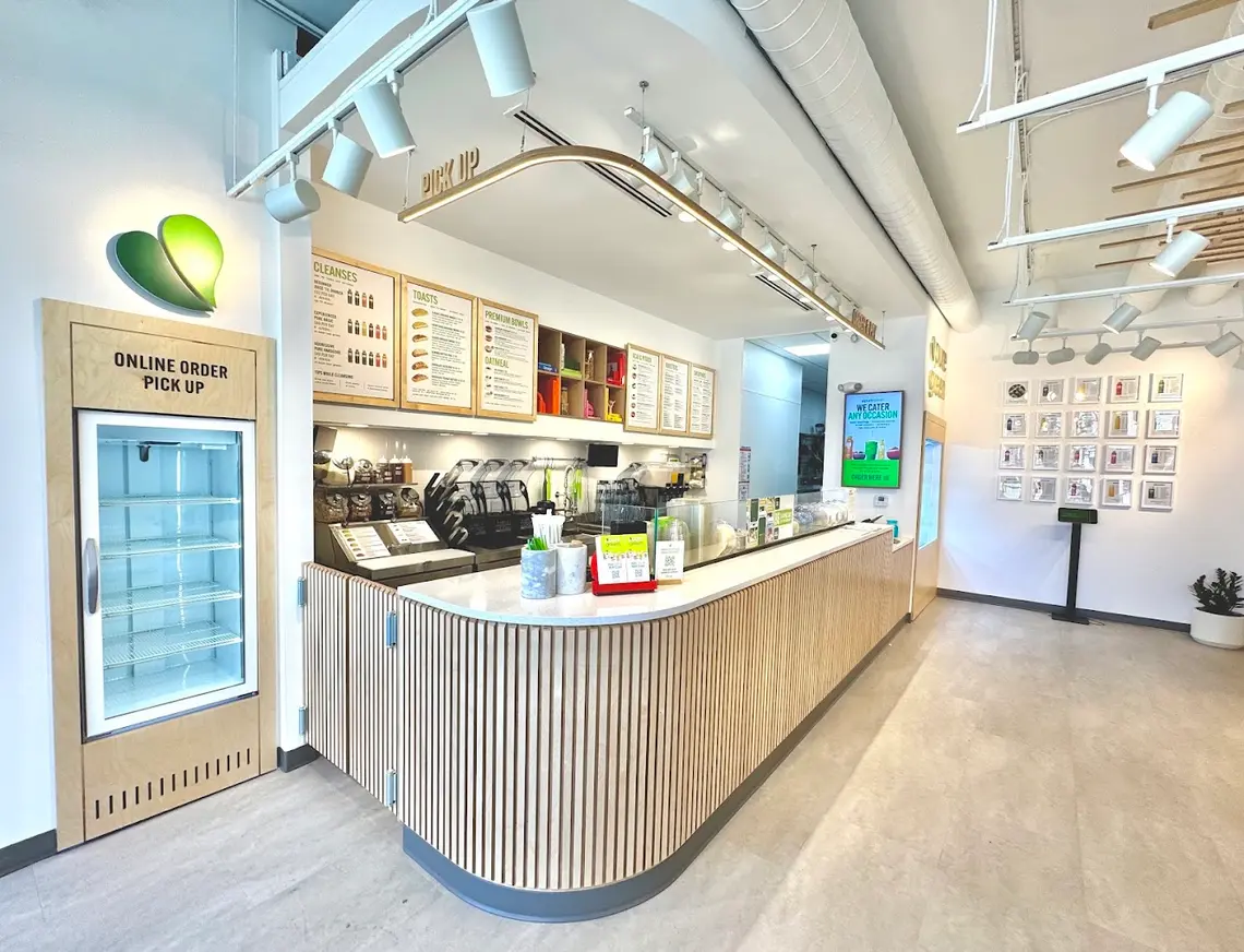 The order counter, menu boards and online order pickup inside Pure Green Montclair