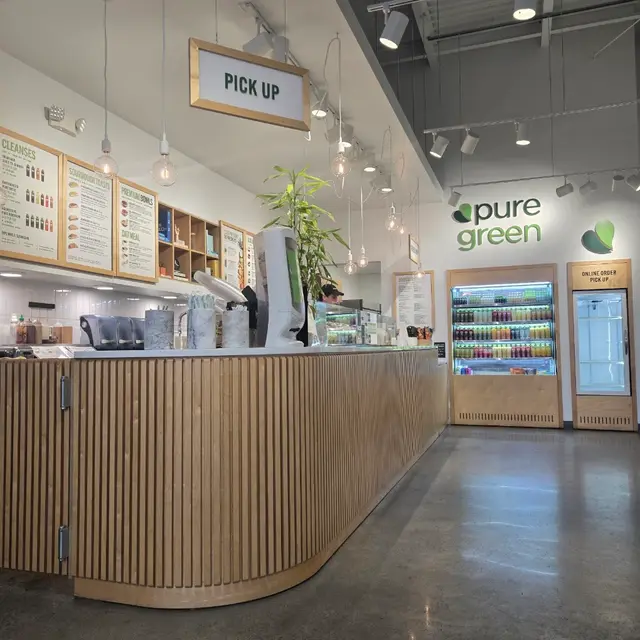 The order counter, cold-pressed juice fridge and online order pickup at Pure Green Clayton