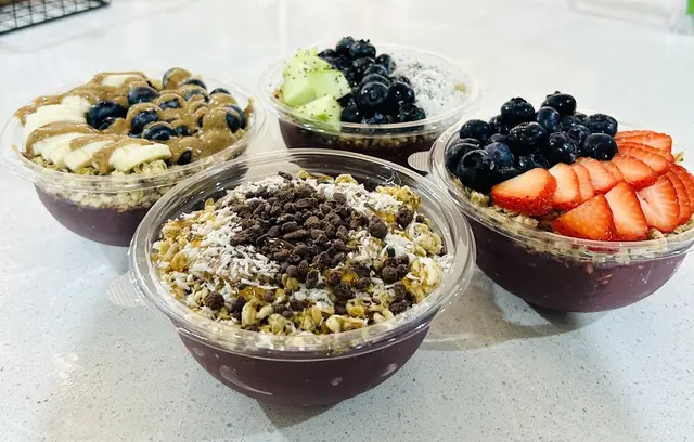 Four acai bowls topped with fruit, granola and nut butter at Pure Green Newtown