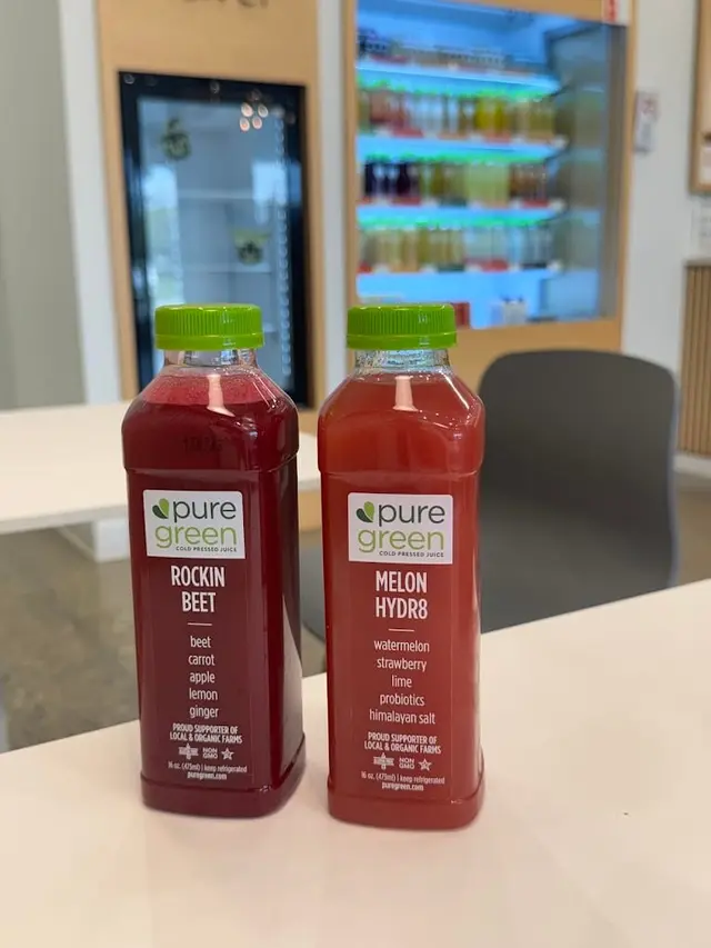 Rockin Beet and Melon HYDR8 cold-pressed juices on the counter at Pure Green Sterling Heights